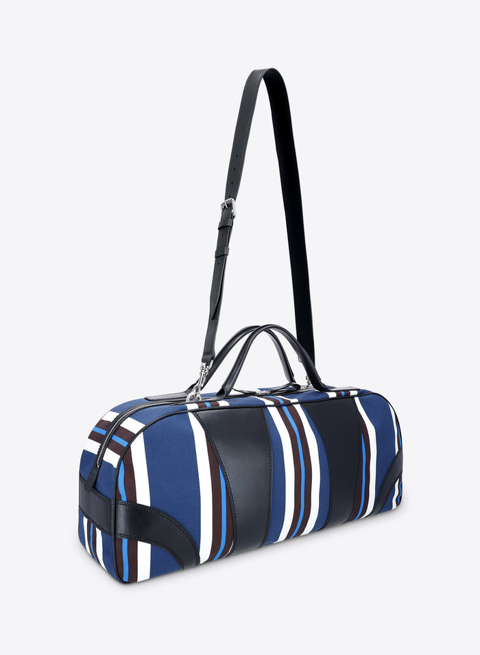 Blue and white striped duffel bag with black accents on a light gray background - Dries Van Noten