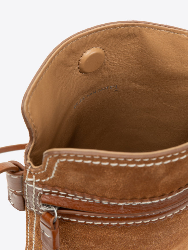 Close-up of a brown leather bag with visible stitching on a white background - Dries Van Noten