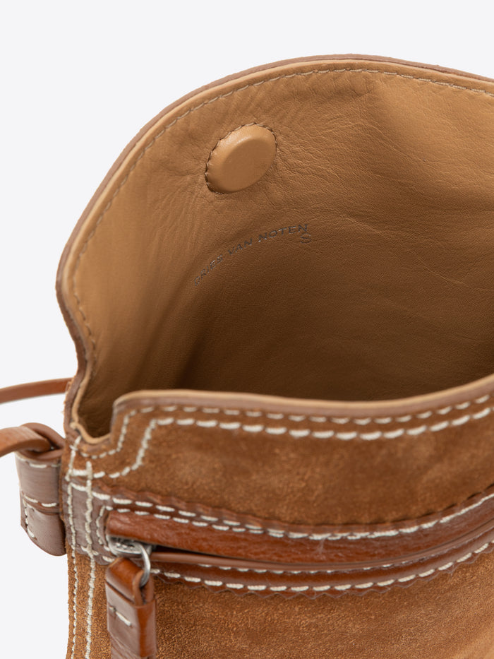 Close-up of a brown leather bag with visible stitching on a white background - Dries Van Noten