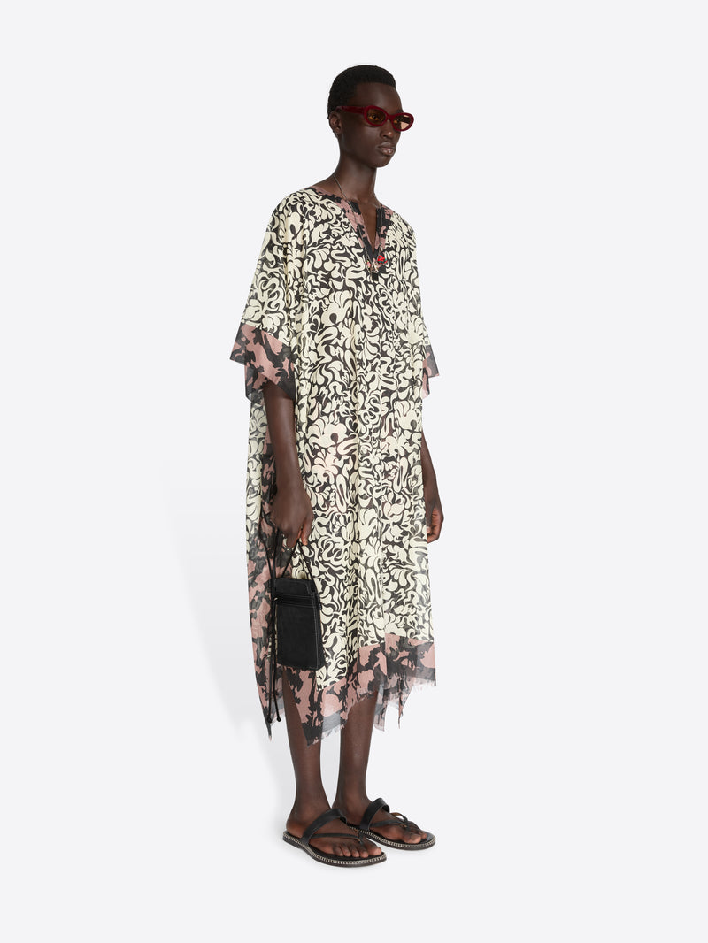 Woman wearing a floral dress with sheer sleeves on a white background - Dries Van Noten