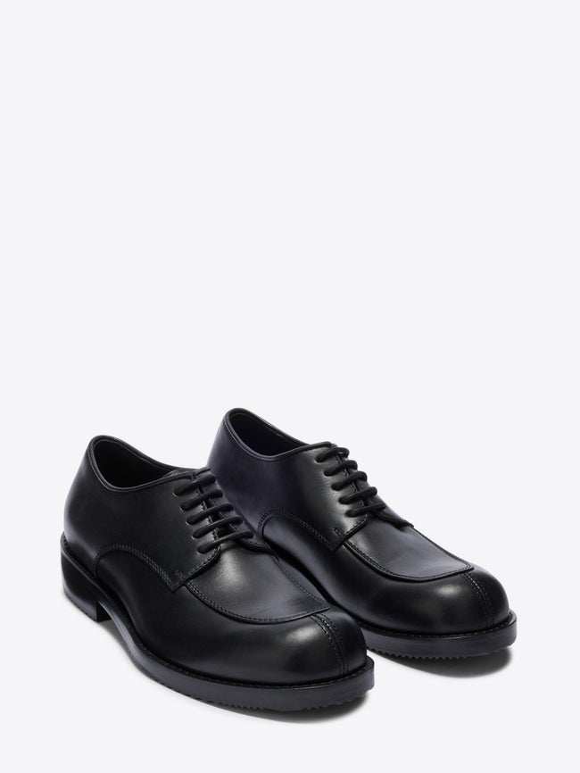Pair of black leather shoes on a white background - Dries Van Noten
