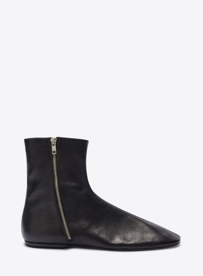 Black ankle boot with a zipper on a white background