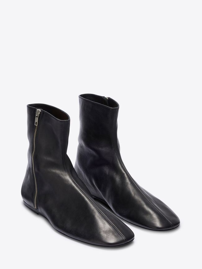 Pair of black leather ankle boots on a white background