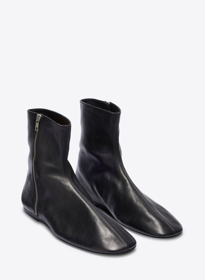 Pair of black leather ankle boots on a white background