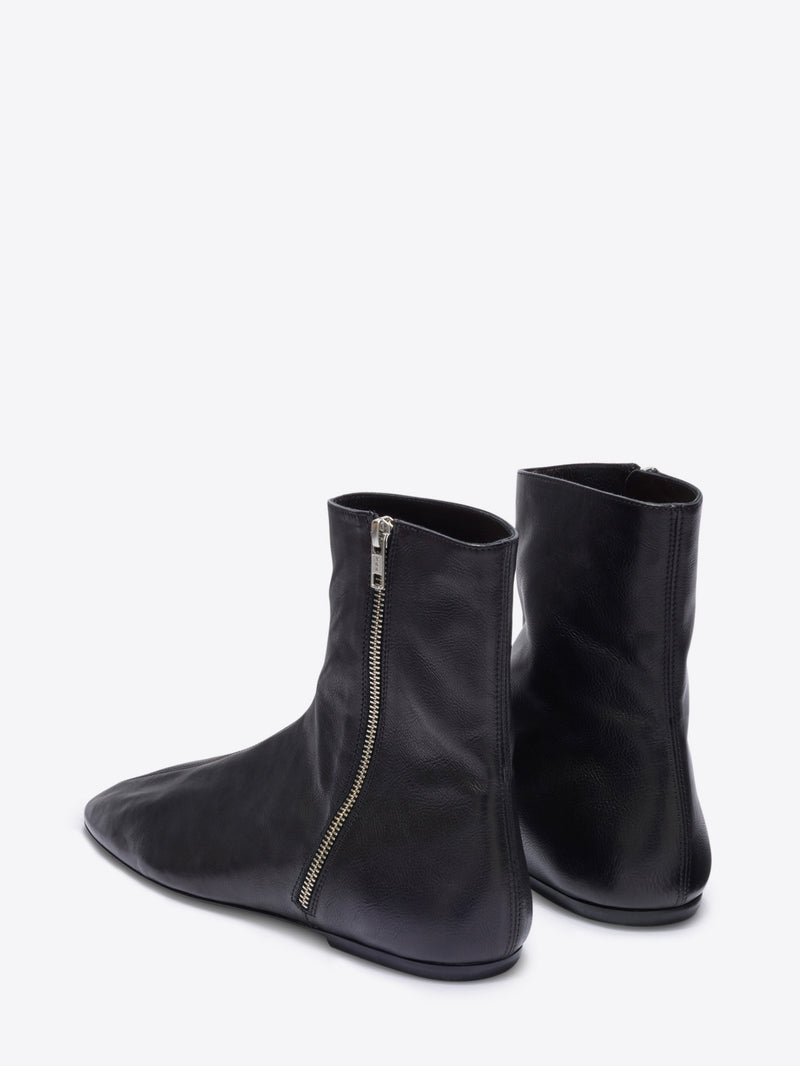 Black ankle boots with a zipper on a white background
