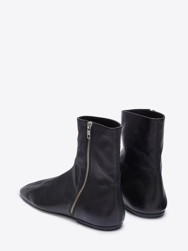Black ankle boots with a zipper on a white background
