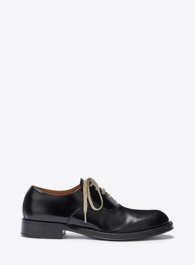 Black leather shoe with white laces on a white background - Dries Van Noten