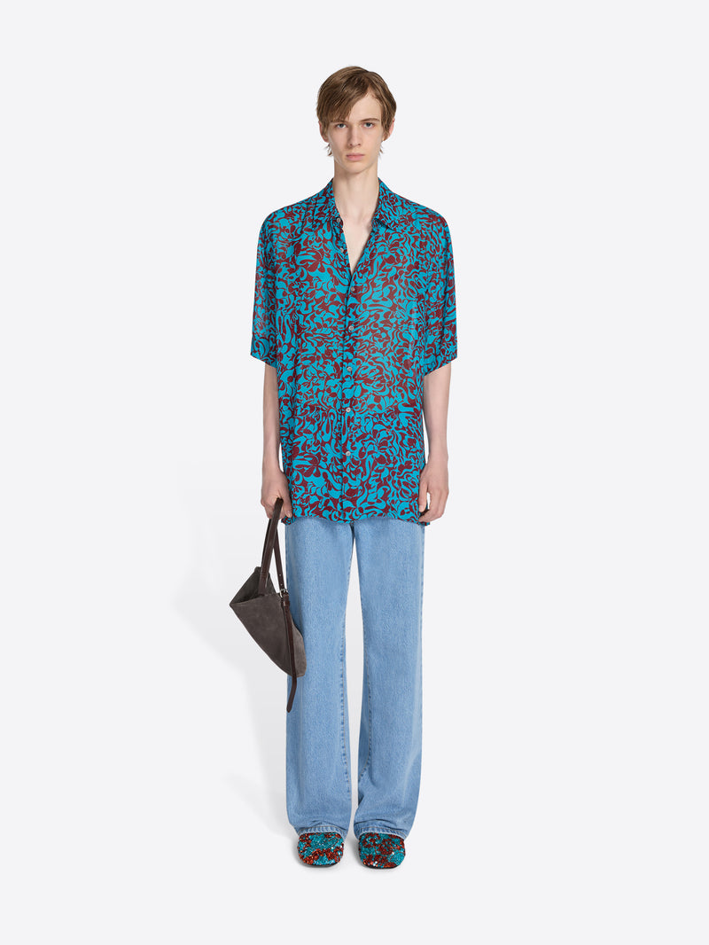 Person wearing a patterned outfit on a white background - Dries Van Noten