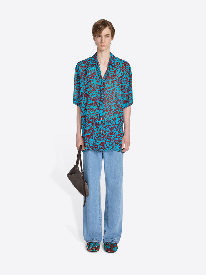 Person wearing a patterned outfit on a white background - Dries Van Noten