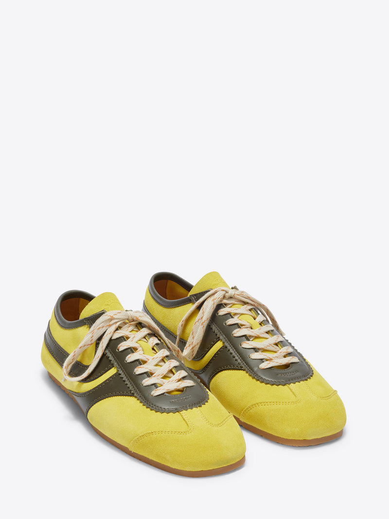 Yellow and gray sneakers on a white background