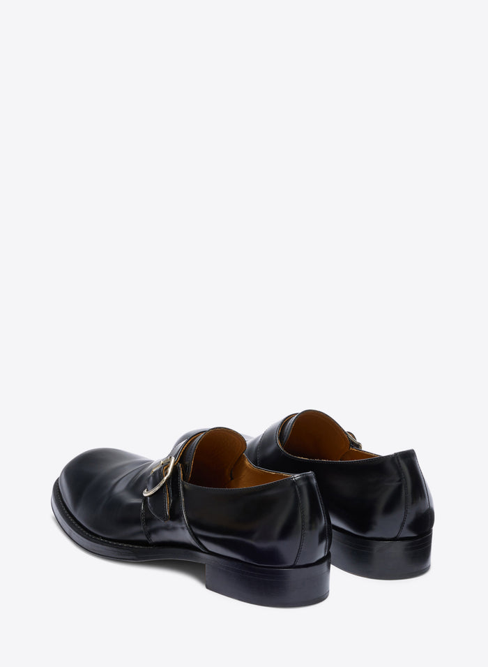 Pair of black leather shoes on a white background