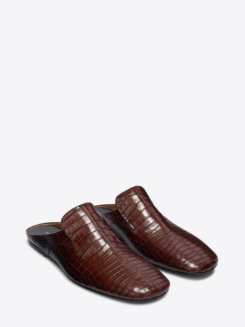 Pair of brown crocodile-patterned slippers on a white background