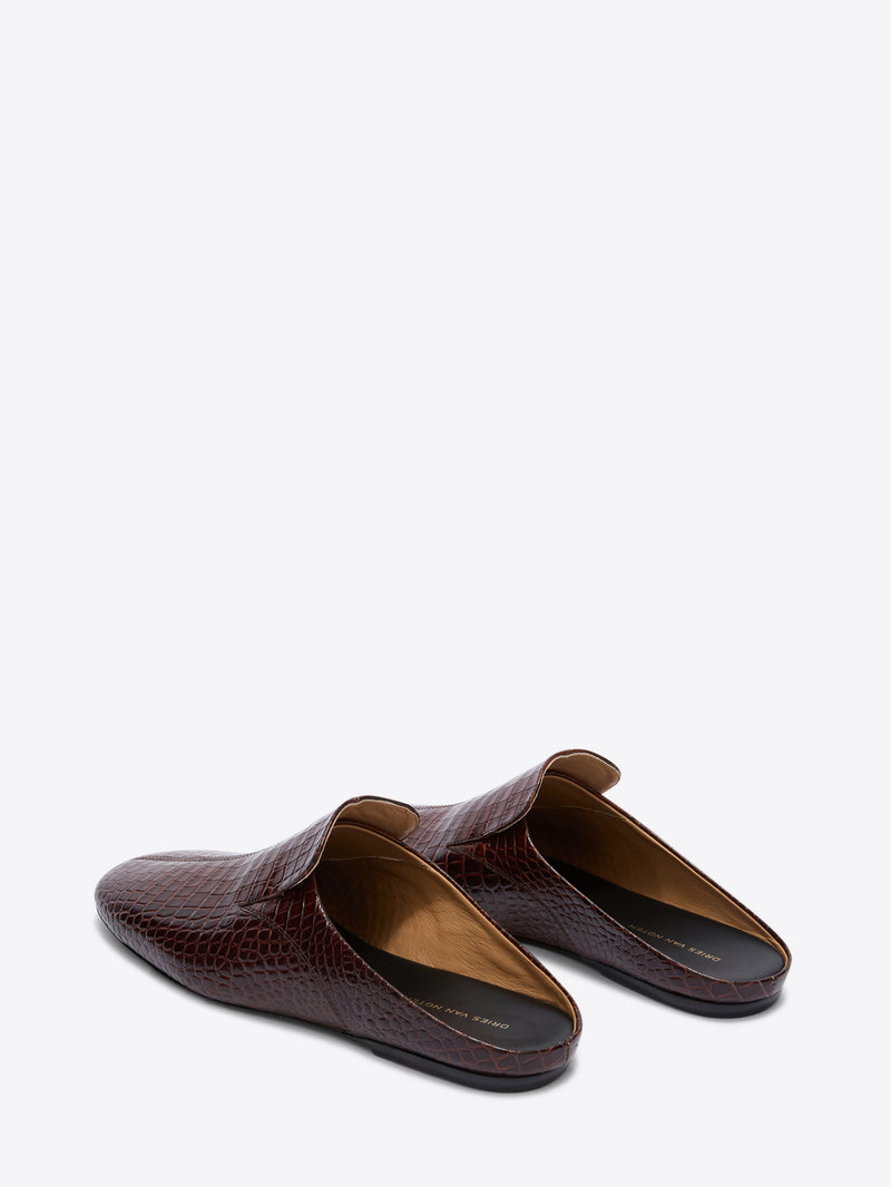 Pair of brown crocodile-textured loafers on a white background
