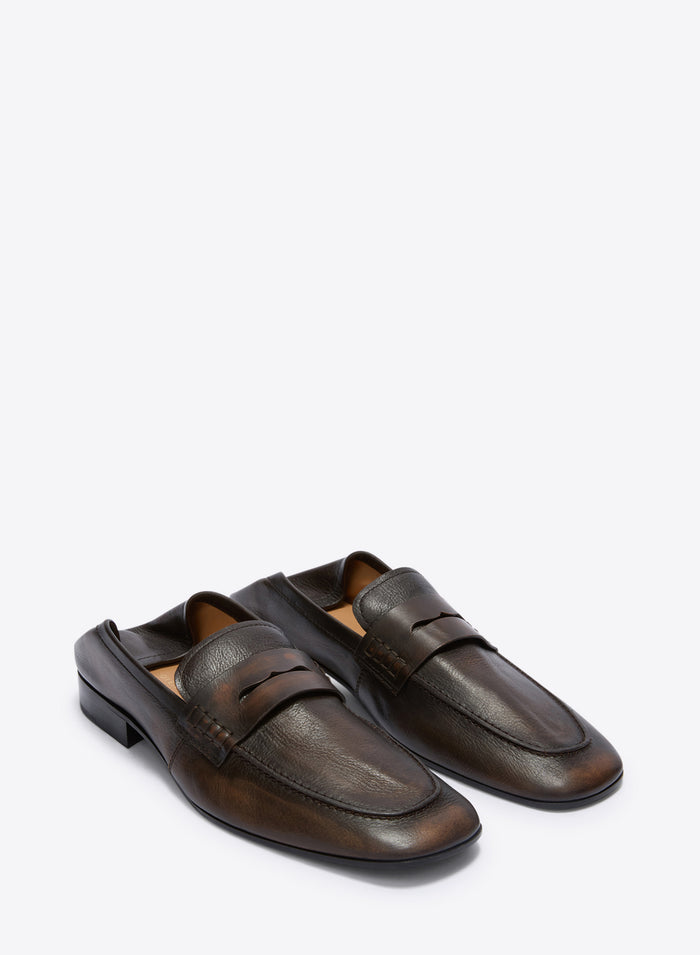 Pair of brown leather loafers on a white background