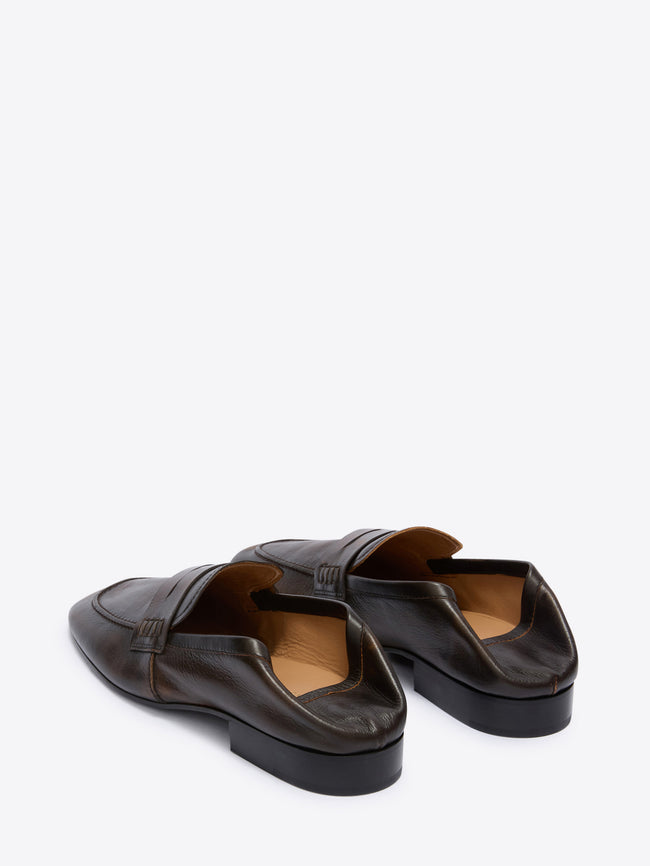 Pair of brown leather loafers on a white background