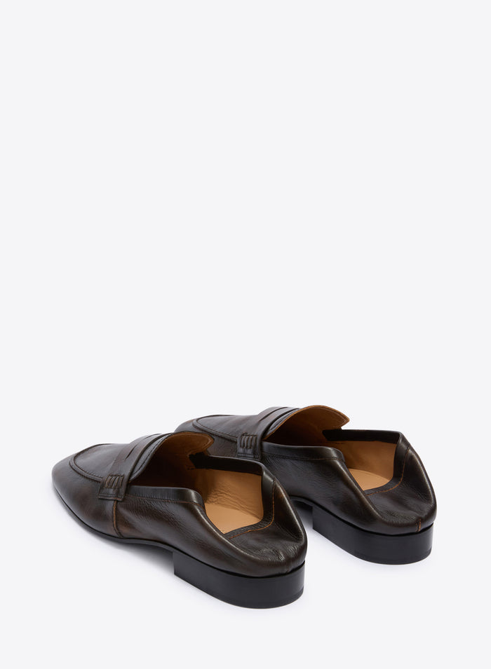 Pair of brown leather loafers on a white background