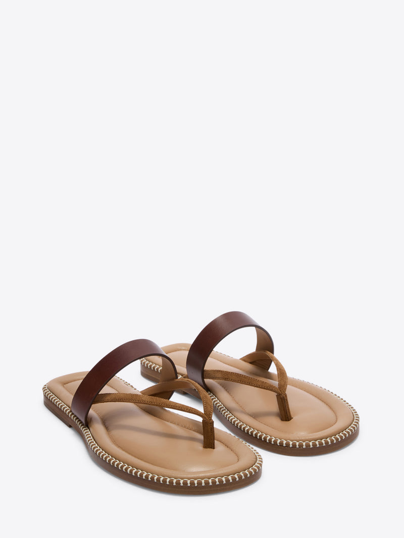 Pair of brown sandals with a white background