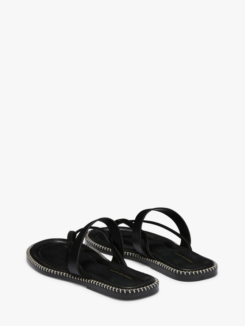 Black sandals with thin straps on a white background