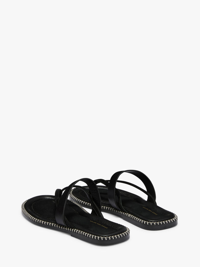 Black sandals with thin straps on a white background