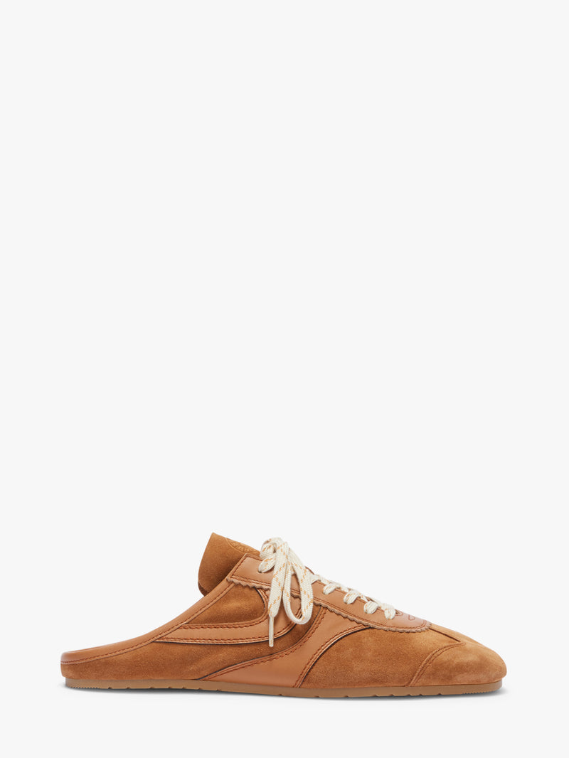 Brown sneaker with white laces on a white background