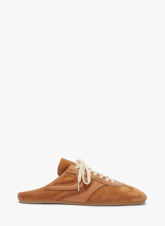 Brown sneaker with white laces on a white background