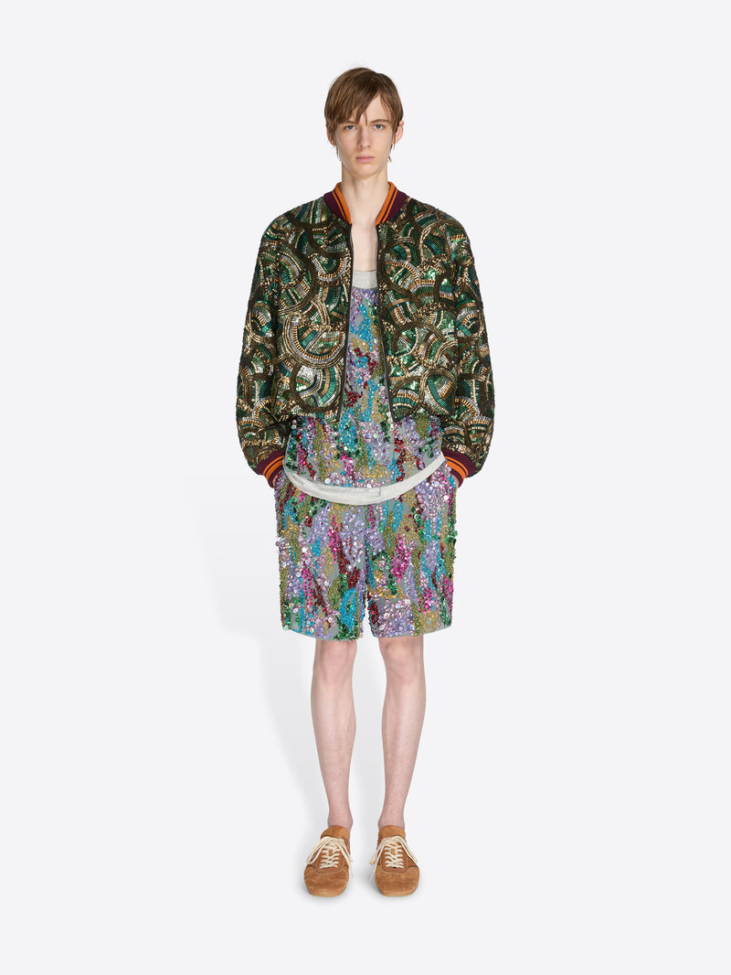 Person wearing a patterned outfit on a white background