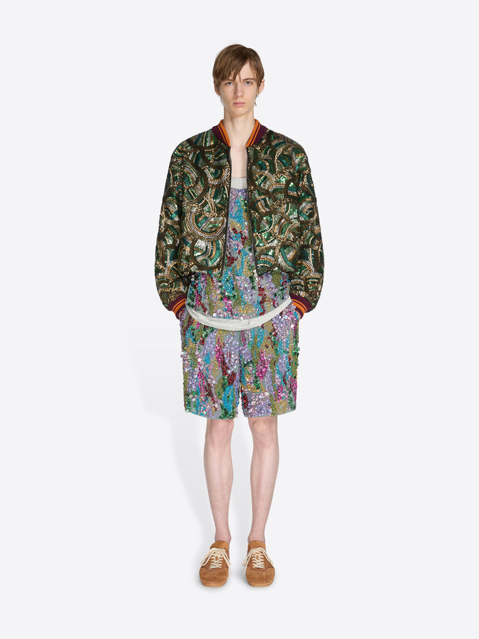 Person wearing a patterned outfit on a white background