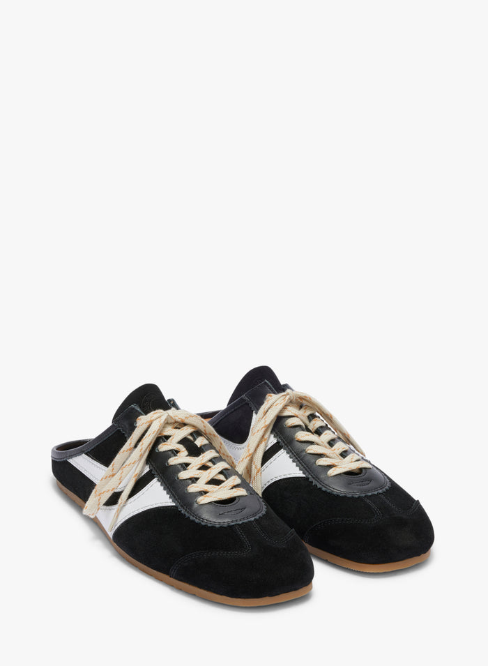 Black and white sneakers with brown soles on a white background