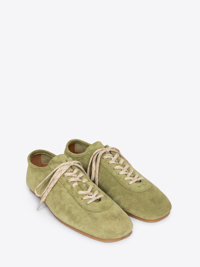 Pair of green suede shoes with beige laces on a white background