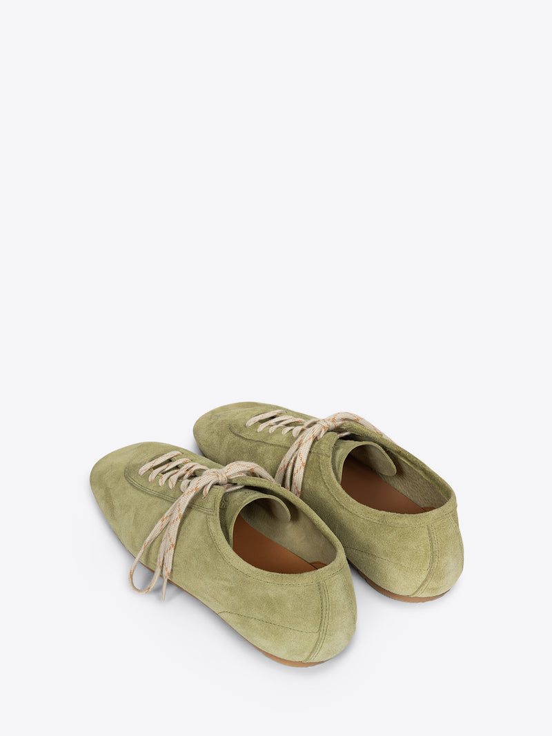 Pair of green shoes with brown soles on a white background
