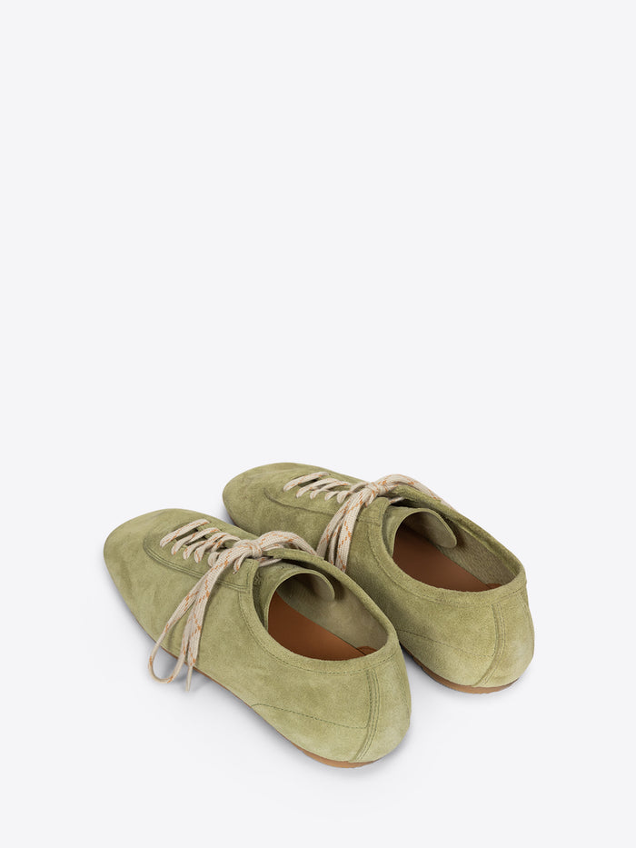 Pair of green shoes with brown soles on a white background