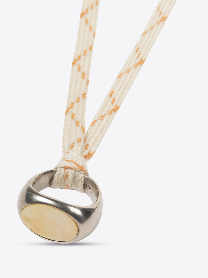 Necklace with a metal clasp and beige rope on a white background