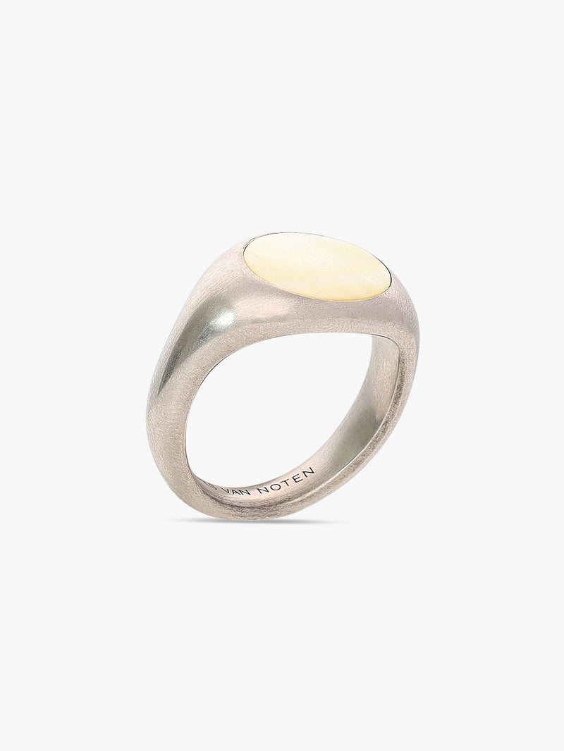 Silver ring with a yellow gemstone on a white background