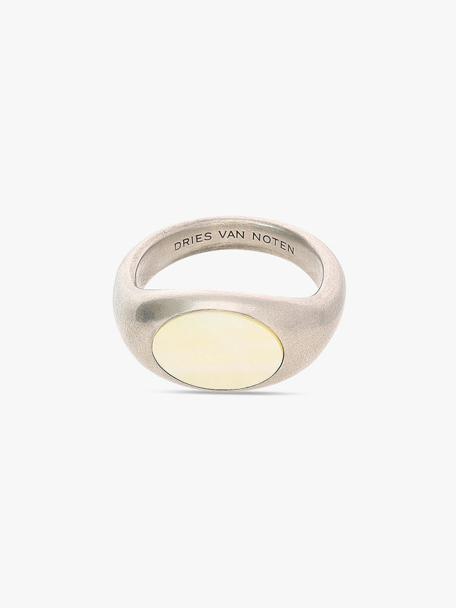 Silver ring with a yellow stone on a white background, featuring 'Dries Van Noten' branding.