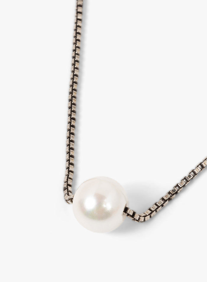Pearl necklace with a chain on a white background