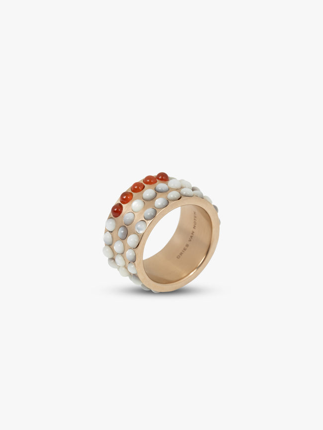 Gold ring with embedded stones on a white background