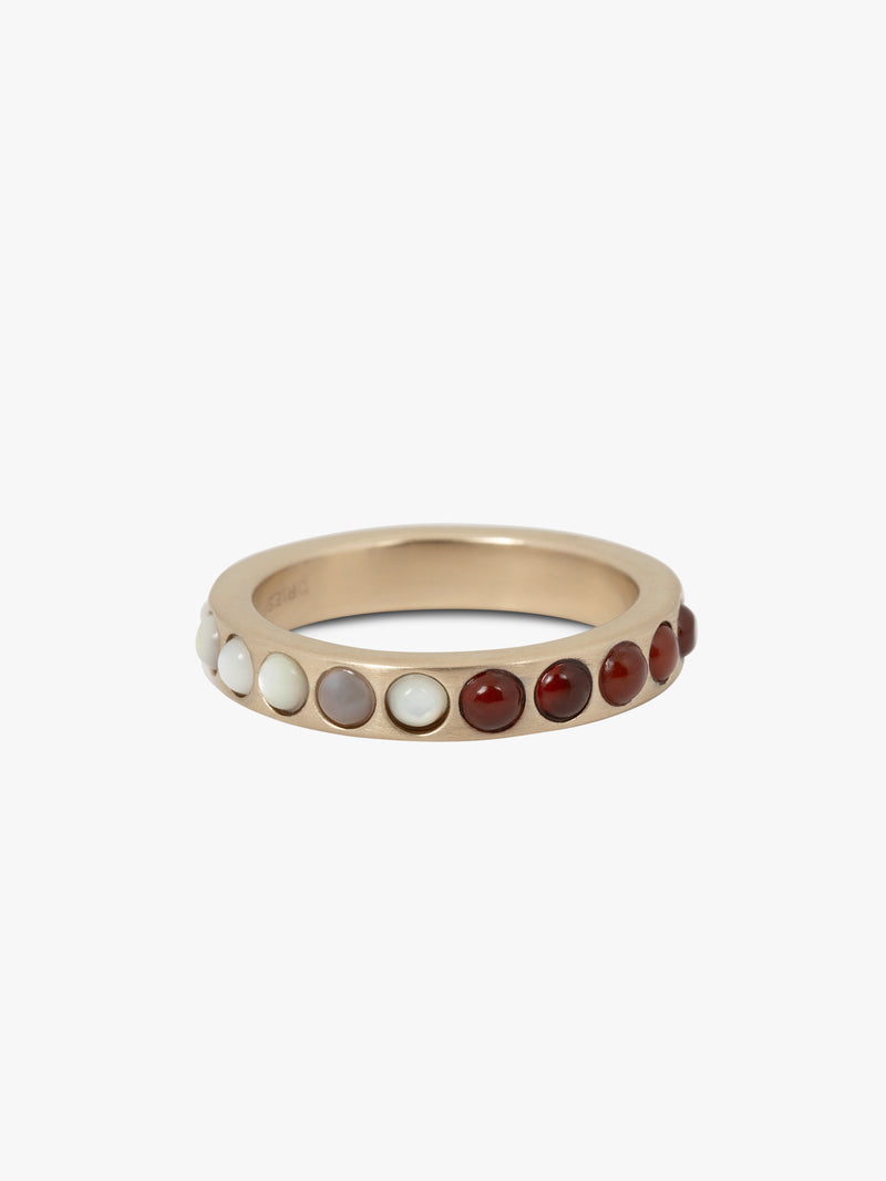 Gold ring with embedded stones on a white background
