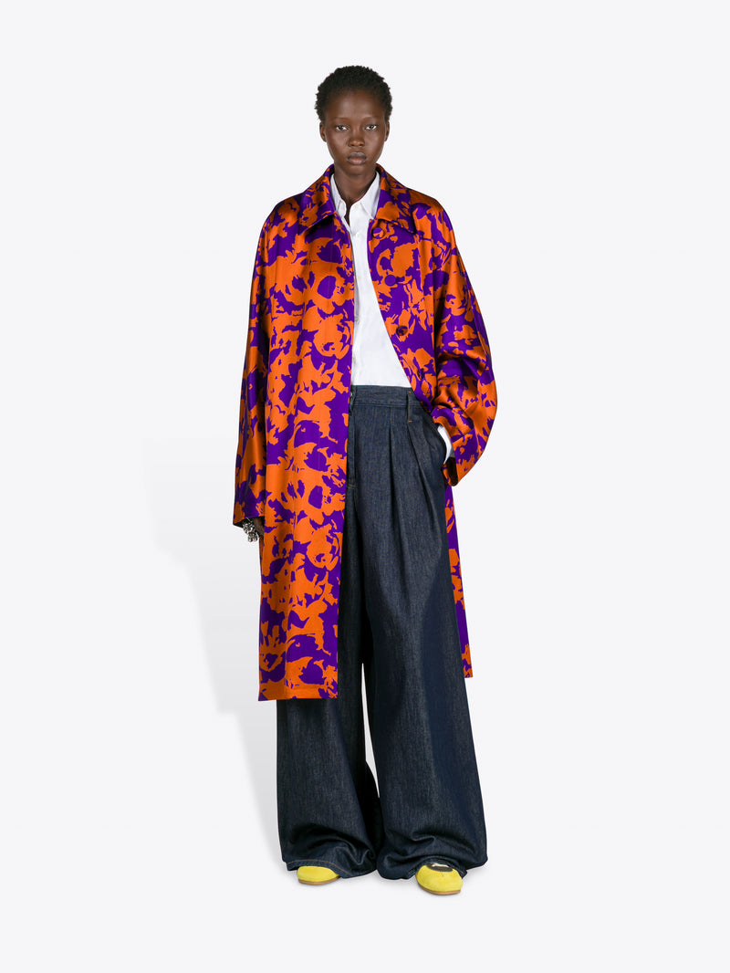 Person wearing a colorful coat with a white background