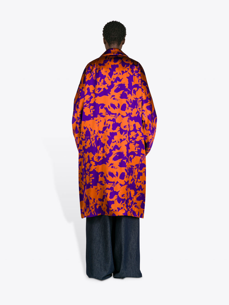 Person wearing a colorful coat with a white background