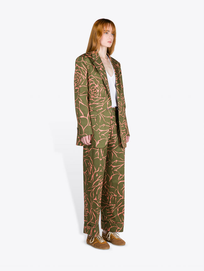 Person wearing a green patterned suit on a white background