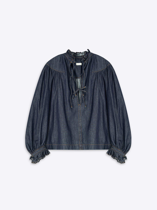 Denim blouse with ruffled sleeves on a light gray background