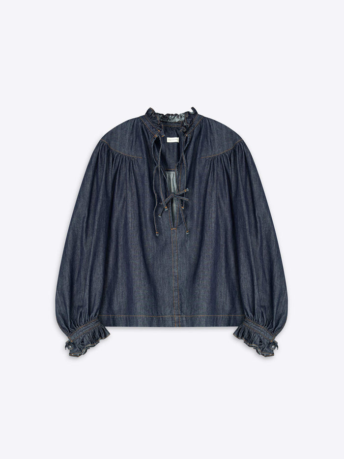 Denim blouse with ruffled sleeves on a light gray background
