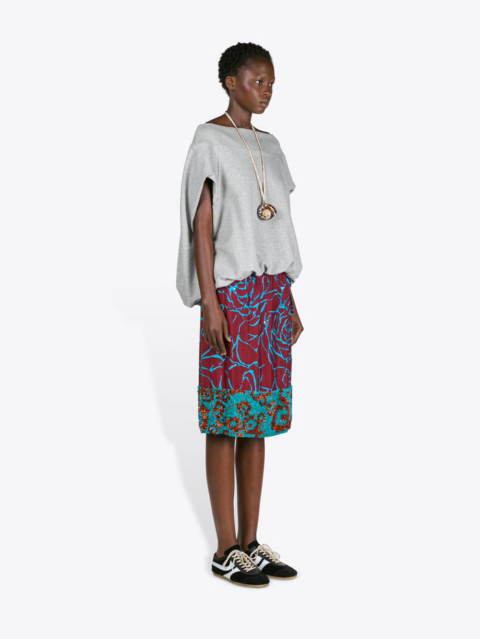 Woman wearing a white top and colorful skirt on a white background - Dries Van Noten