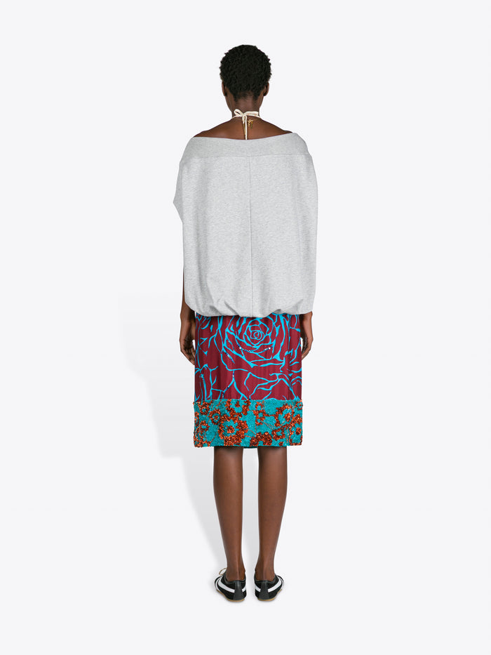Woman wearing a grey top and colorful skirt on a white background - Dries Van Noten