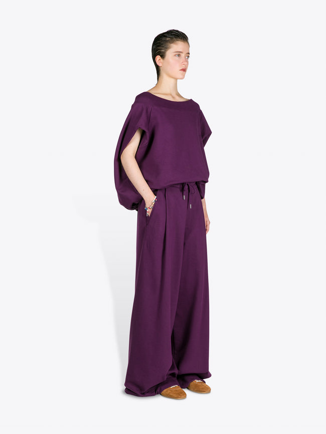 Person wearing a purple outfit on a white background