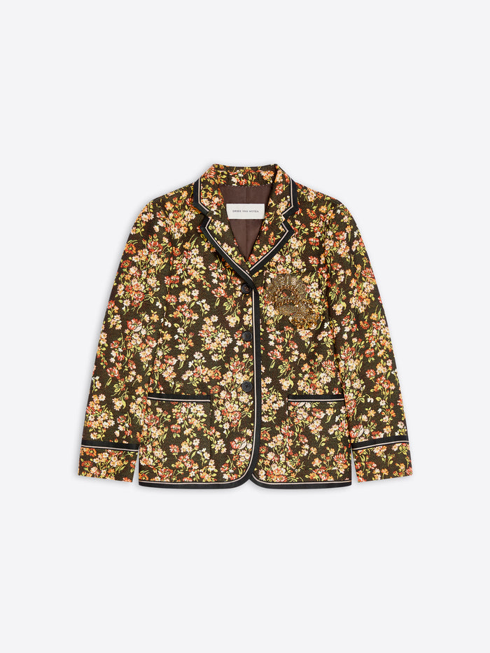 A women's blazer jacket featuring an all-over dense floral print with contrasting black piping along the collar, front, cuffs, and hem.