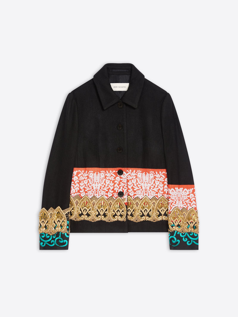A black long-sleeve button-up jacket featuring a wide multicolor patterned band across the waist and cuffs, with gold and turquoise details, shown on a light gray background.