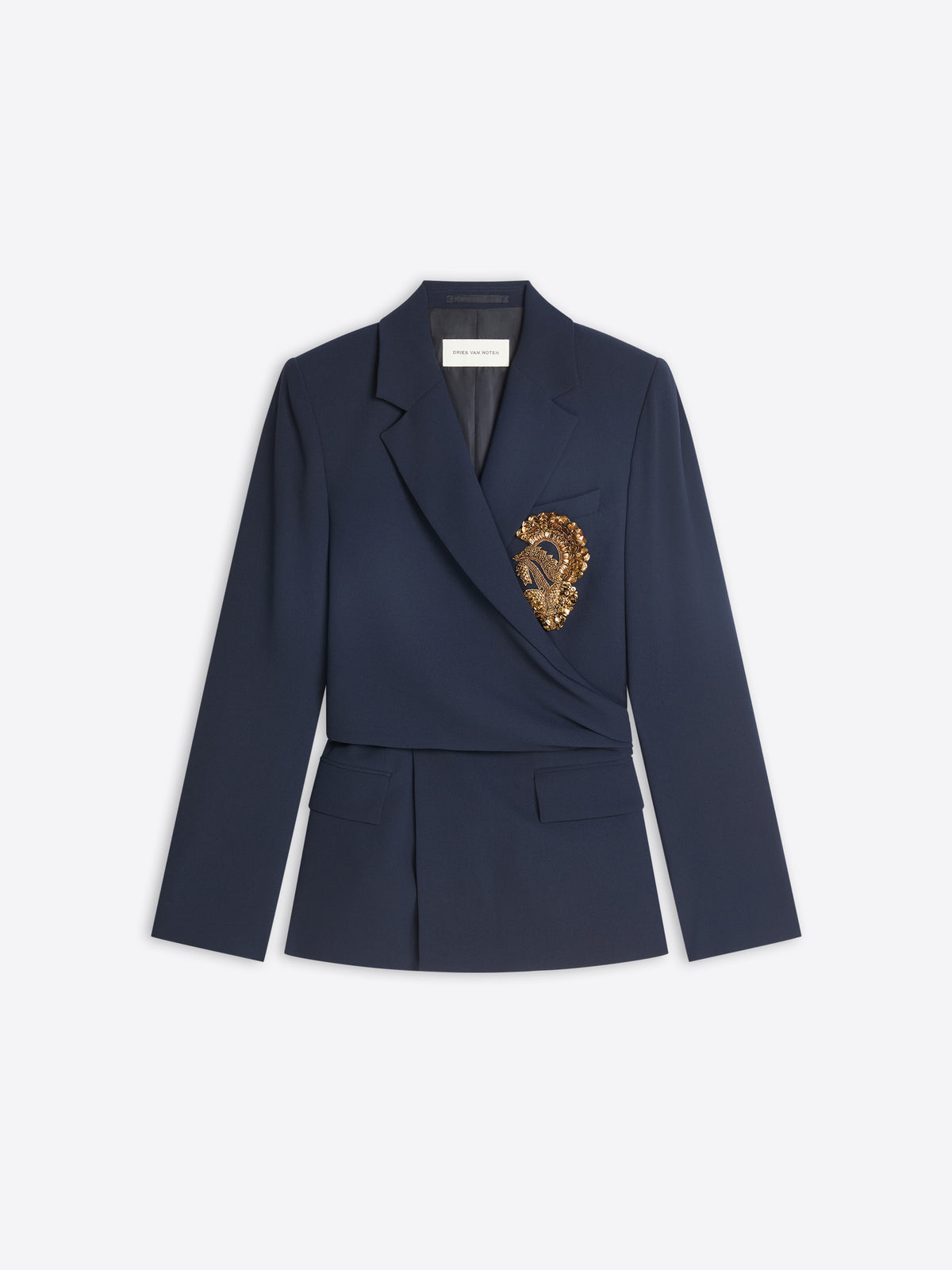 A navy blue wrap-style blazer with a structured waist and a decorative gold embroidered detail on the left chest, displayed against a light gray background.