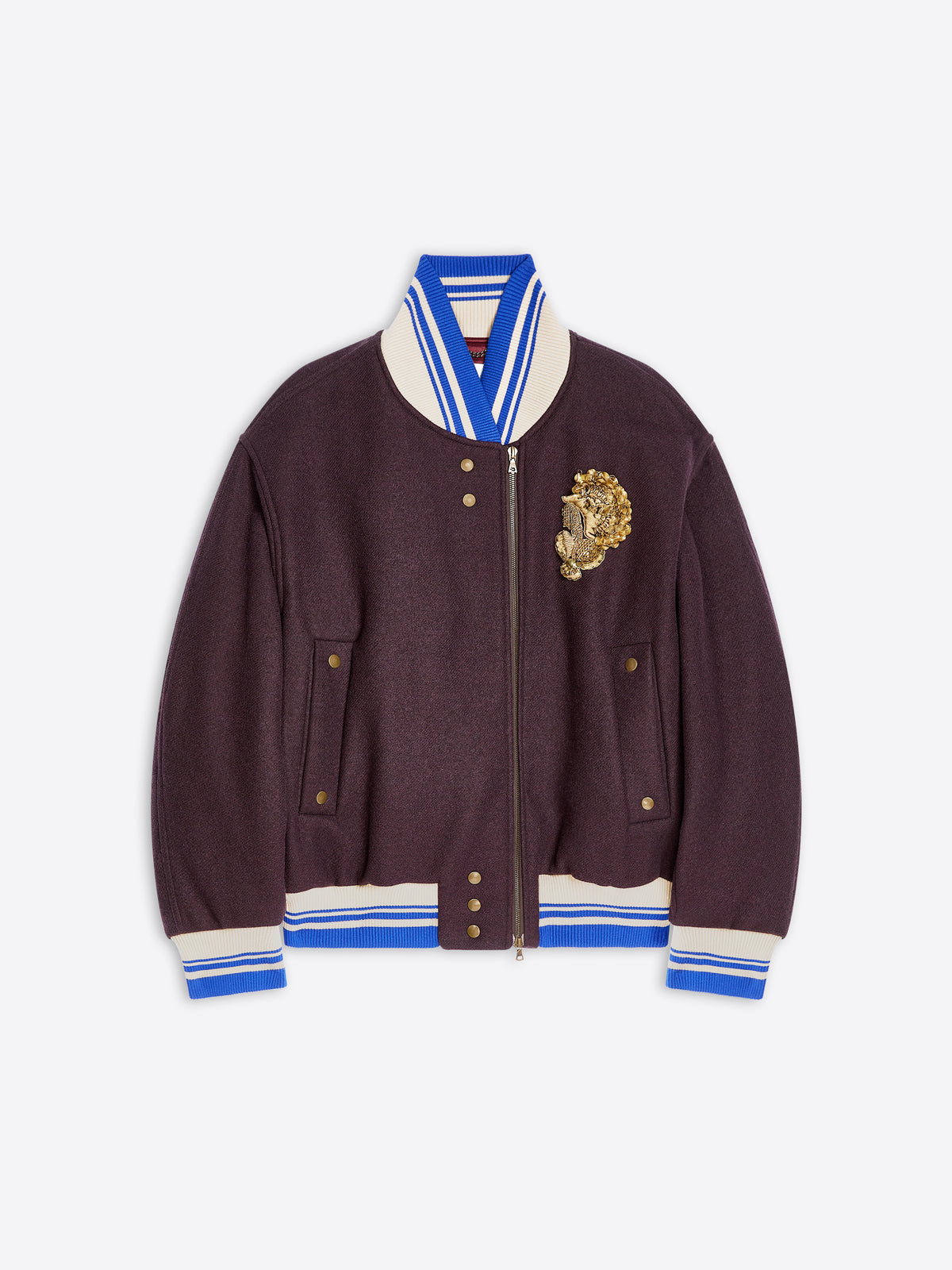 A dark plum varsity-style jacket with cream and blue striped ribbed trim, a gold embroidered detail on the left chest, and a front zipper, shown on a light gray background.