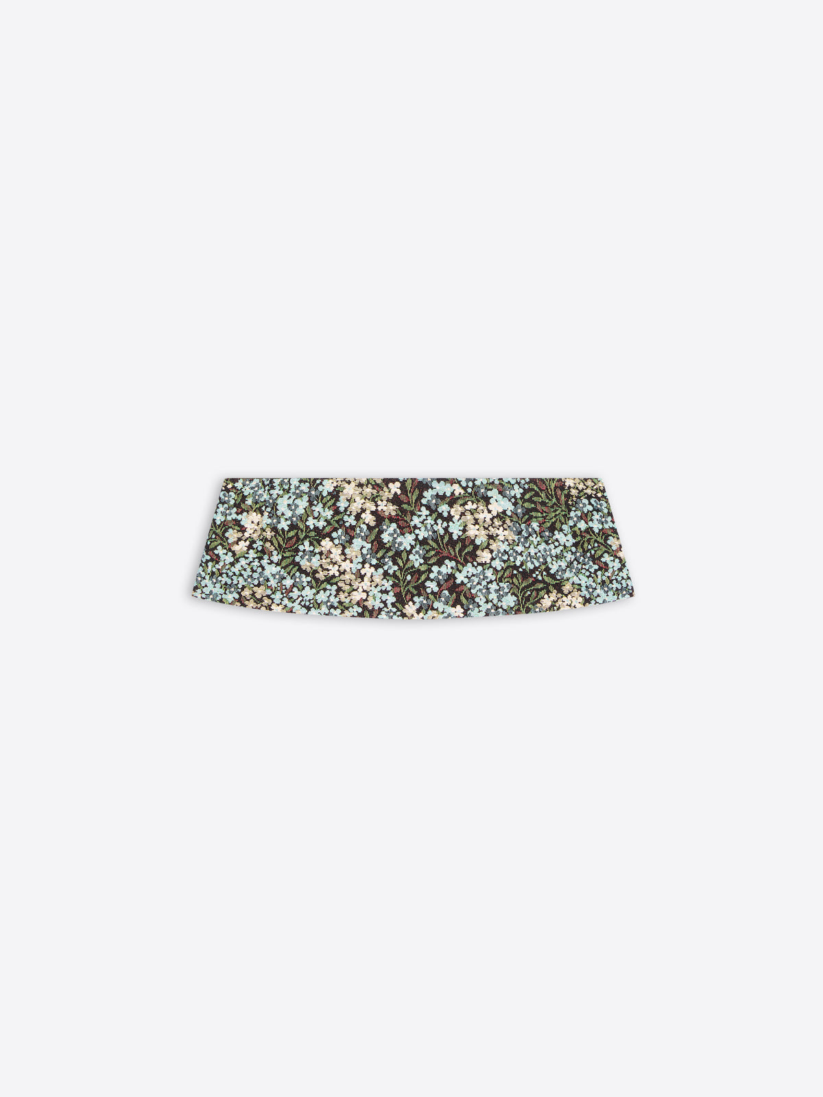 A wide, structured pleated waist band with a dense floral pattern in muted green, beige, and light blue, shown against a light gray background.